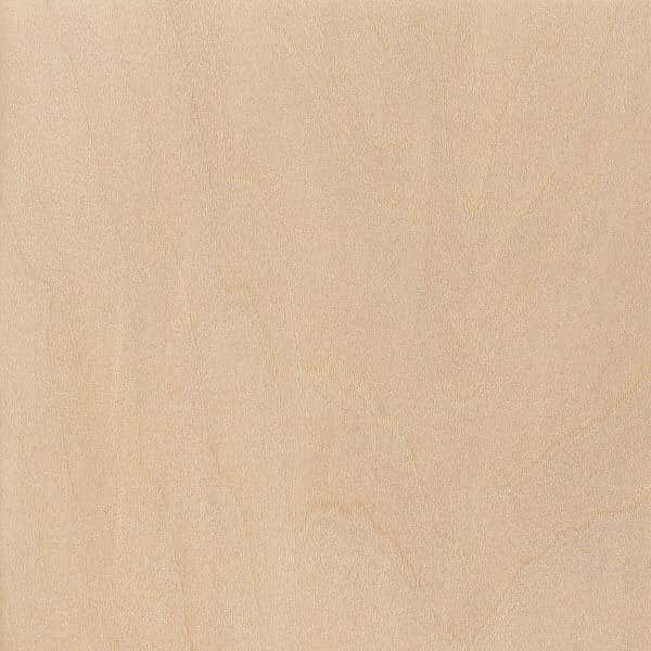 A close view of a pale basswood face, its grain lines so faint they almost vanish.