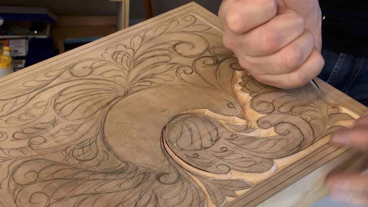 A fist drives the gouge in. Scrollwork drawn everywhere. New cuts showing.