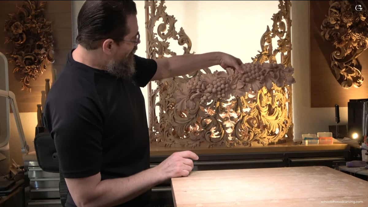 A carved bunch of grapes goes onto a gilded pierced panel