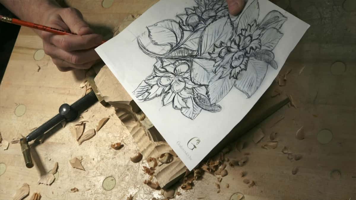 Pencil drawing of hazelnut clusters held above a roughed blank pinned by a brass holdfast