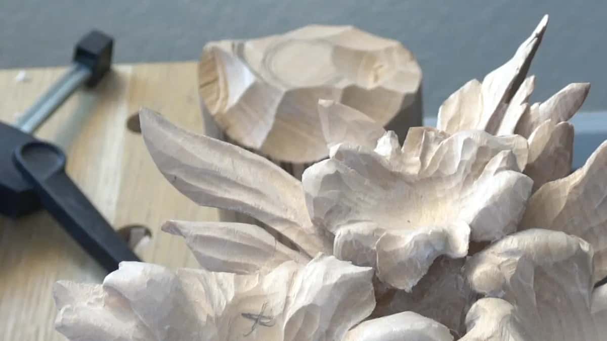 Carved flowers stand well clear of the background, their petals lifting into deep pockets of shadow.