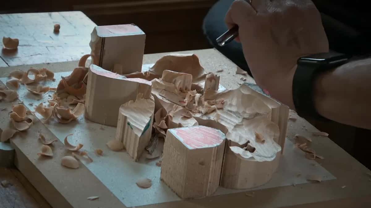 Blocks with pink coloured tops stand above the hollows carved around them in one thick blank.