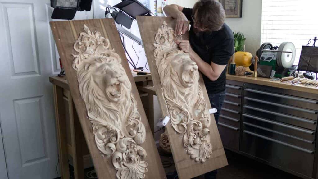 Alexander Grabovetskiy carving one of two matching lion head onlays for a client's doors