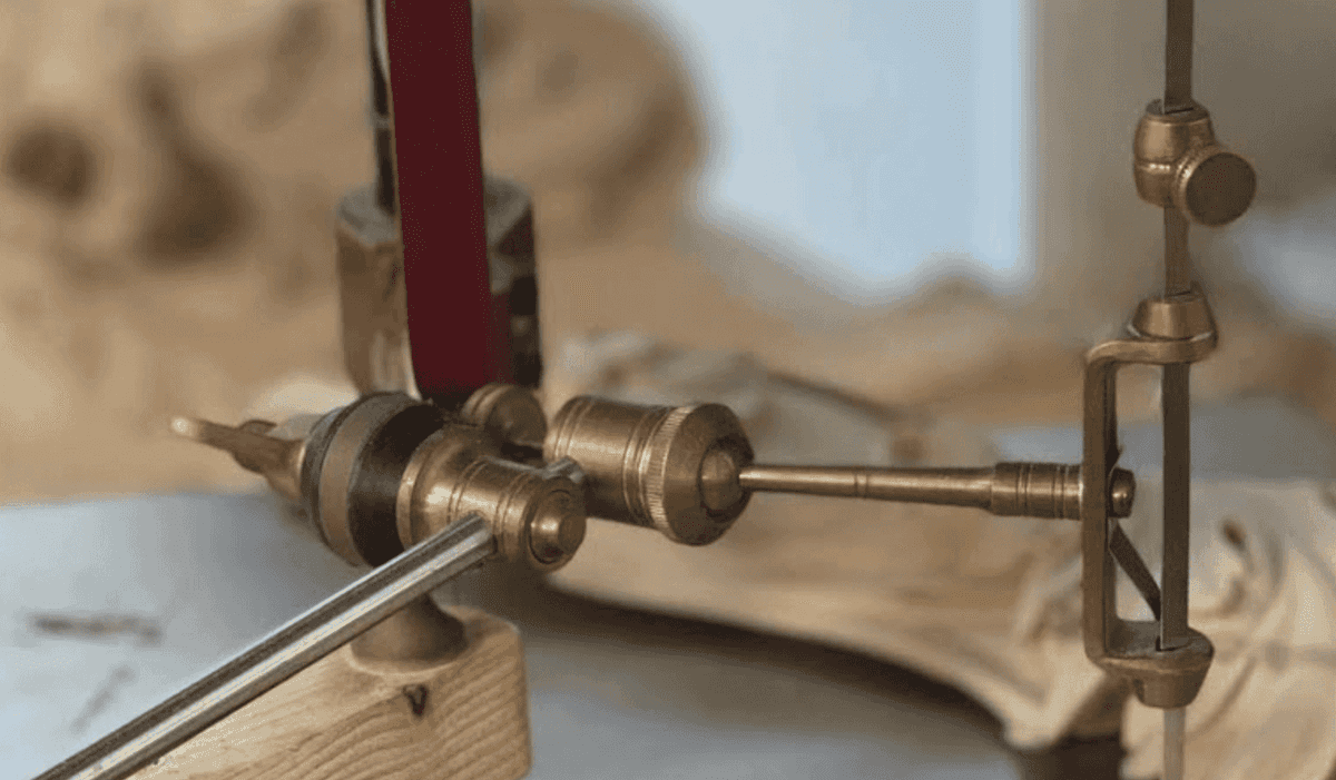 Close-up of various wood carving tools on a workbench, showcasing a precisely crafted tool mechanism designed for detailed wood carving work. This image highlights the essential equipment used in wood carving classes and lessons, perfect for beginners and advanced carvers alike!
