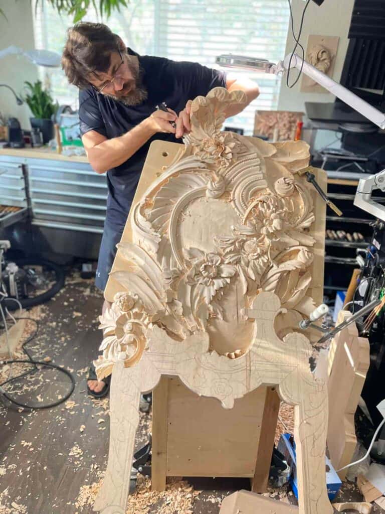 Alexander Grabovetskiy carving a large Venetian style panel in his studio