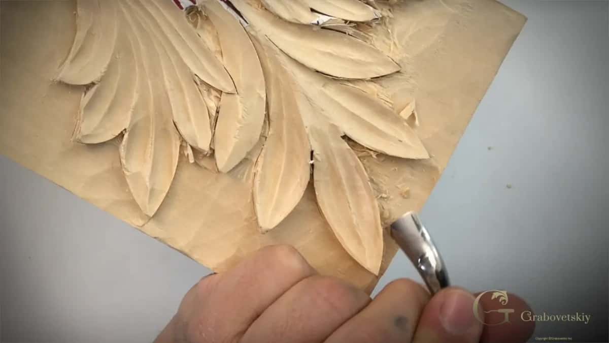 A back bent gouge working under a lobe Reaching in under a carved acanthus lobe with a spoon shaped back bent gouge