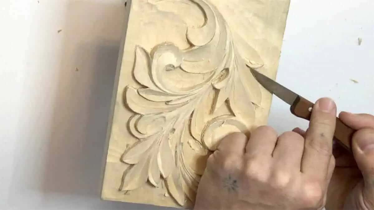 Cleaning an edge with the knife Blade taking the fuzz off a carved acanthus edge