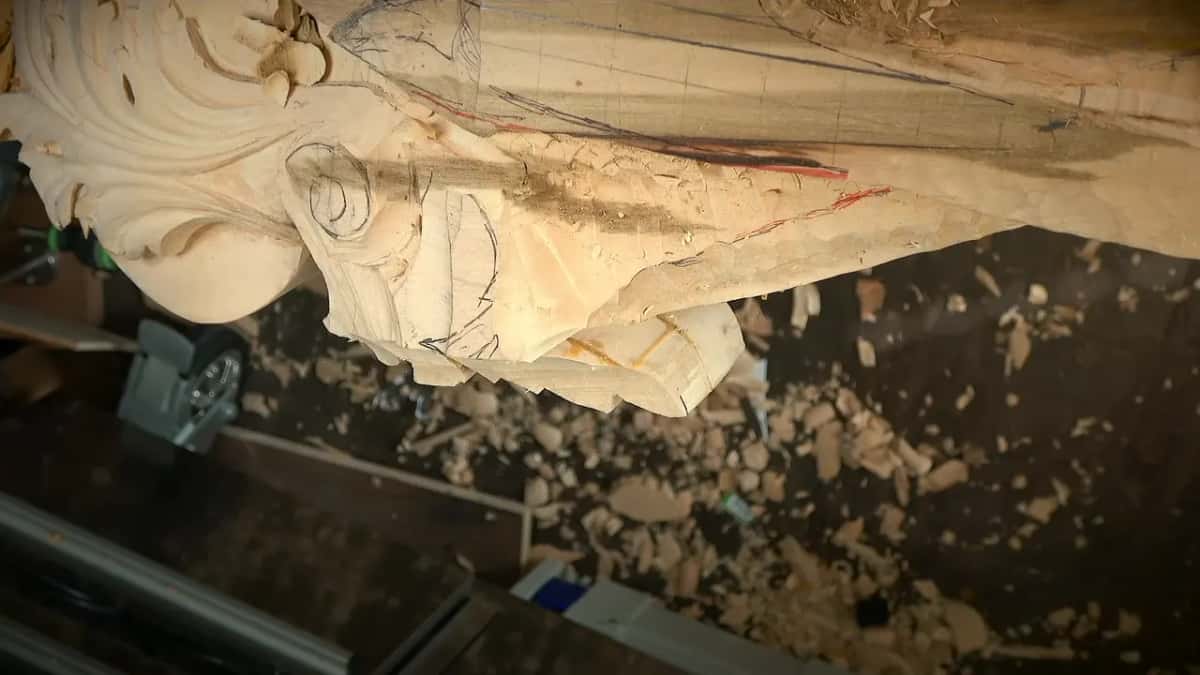 A yellow glue joint shows along the sawn edge of a pale carving built up from more than one piece.