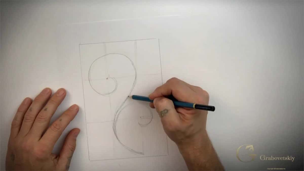 Hands drawing a volute in a ruled square