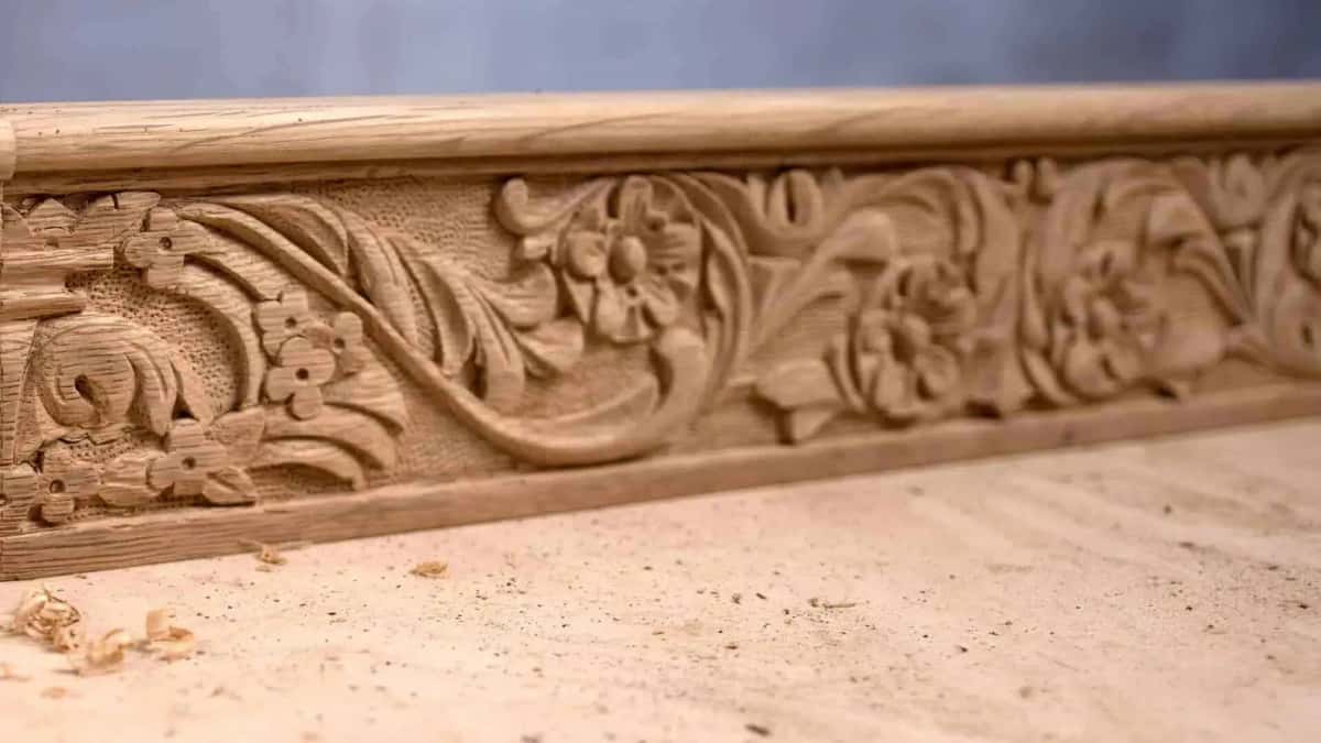 Punched ground stippled behind a carved scroll