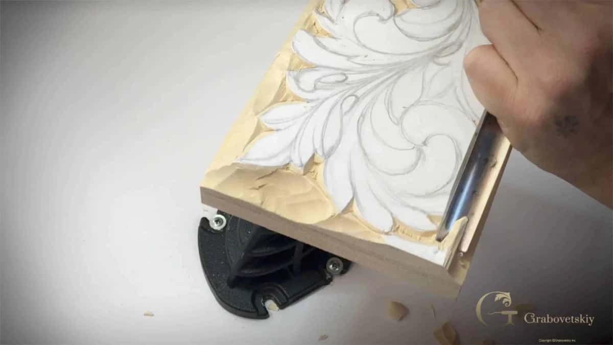 Setting in an acanthus outline with a carving knife Knife riding the drawn outline of a Greek acanthus leaf, worked toward me
