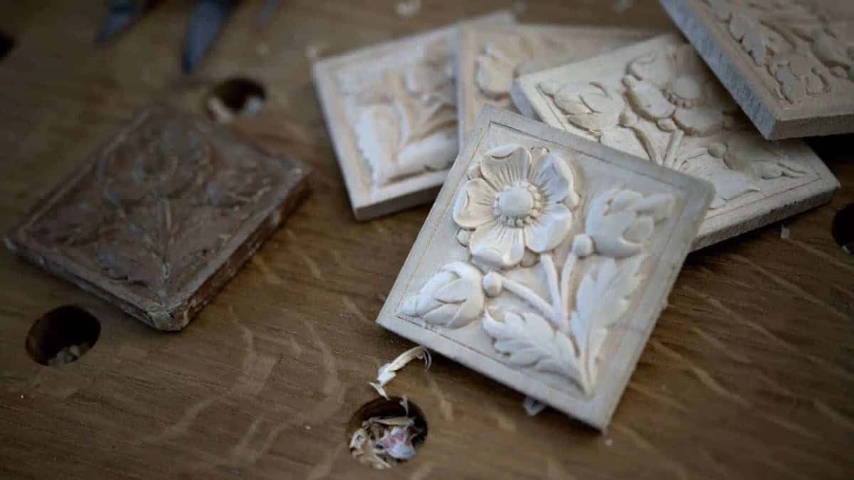 Square flower rosette carvings on the bench beside the antique original